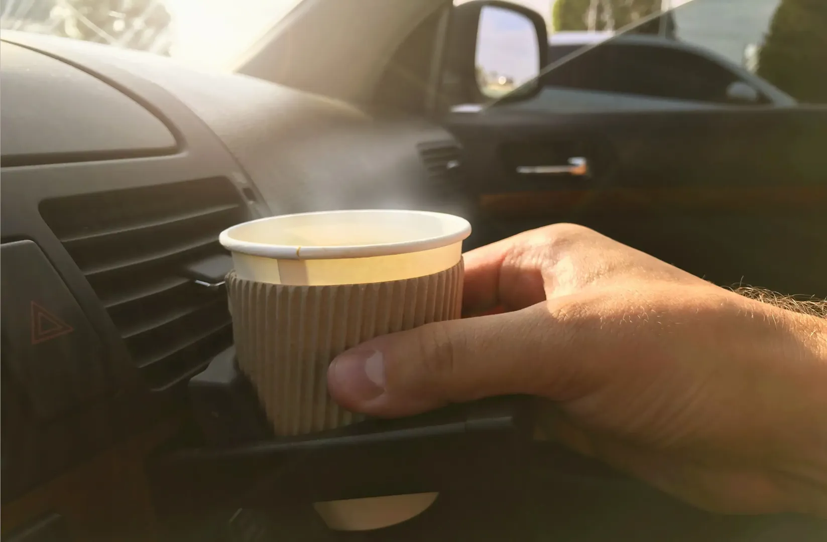 Cup of coffee in car holder