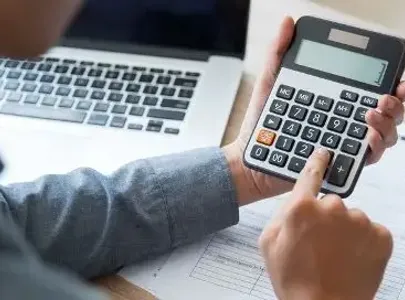 A person using a calculator to perform calculations.