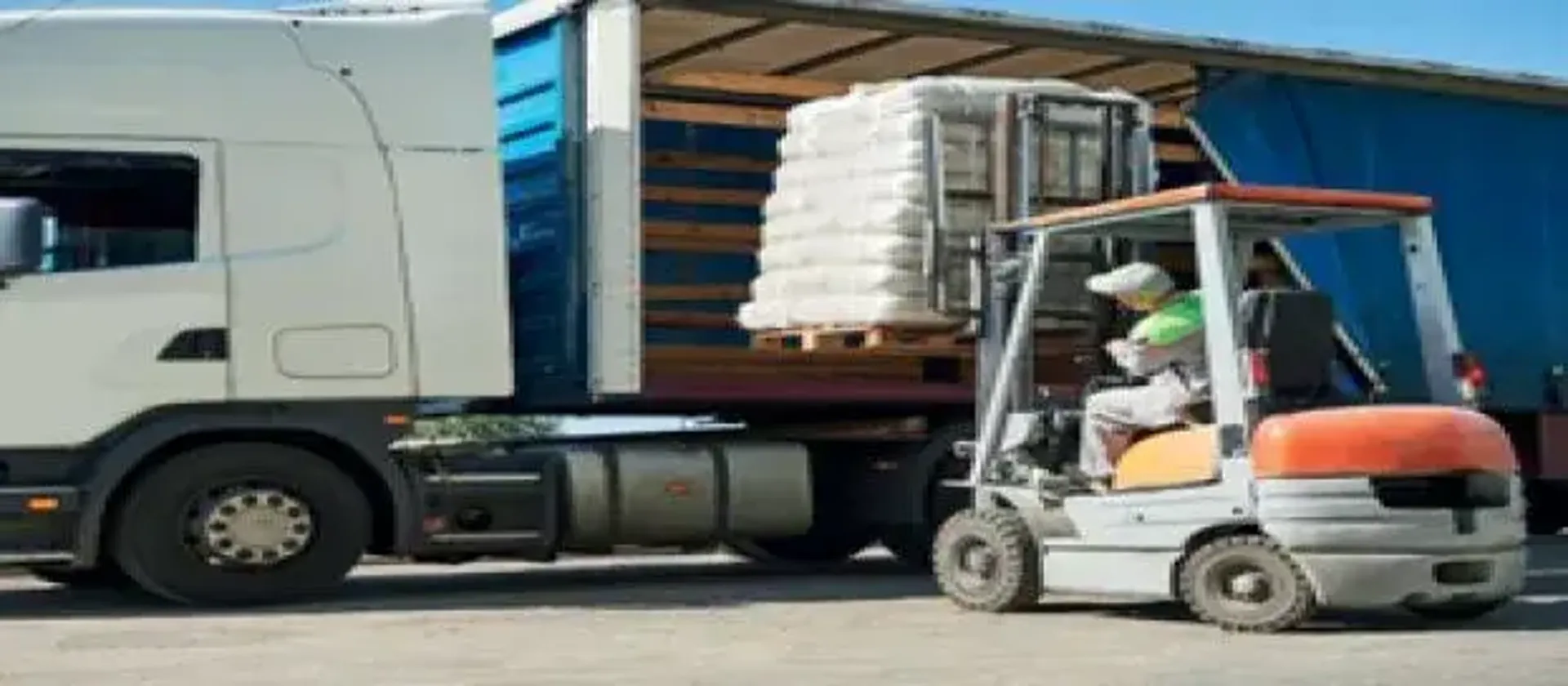Machine loading a pallet of items onto a lorry