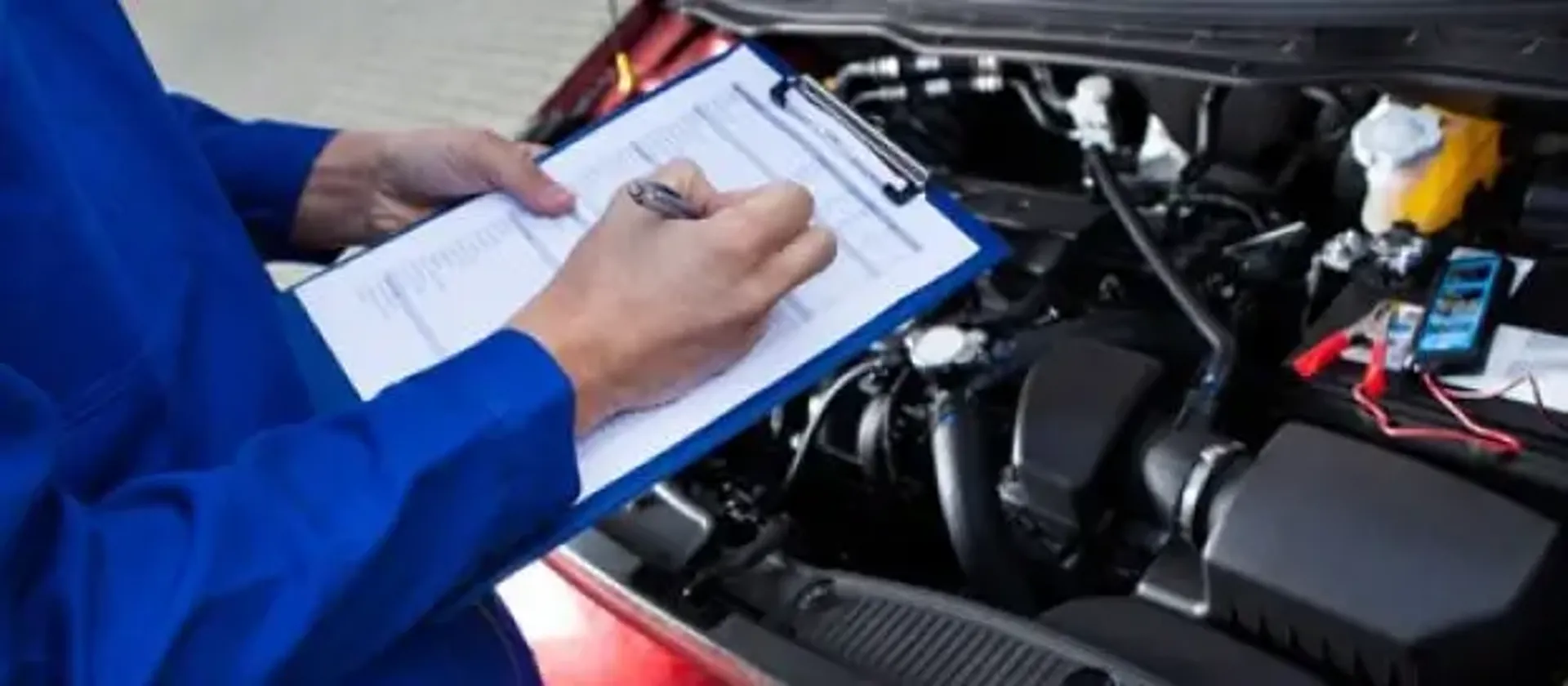 Some one performing an MOT on a car