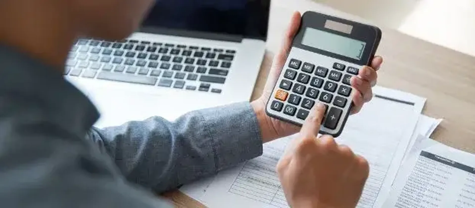 Man using a calculator