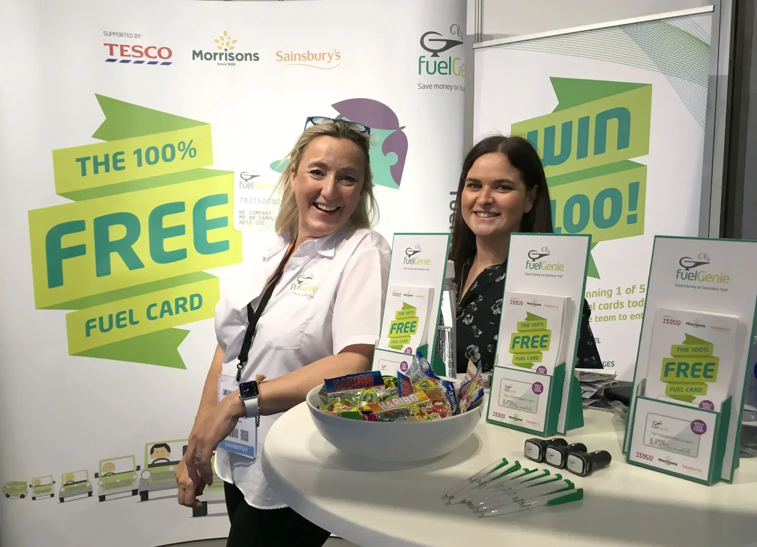 Two women standing at Free Fuel Card stand