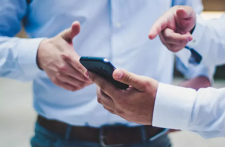 Man pointing at mobile phone