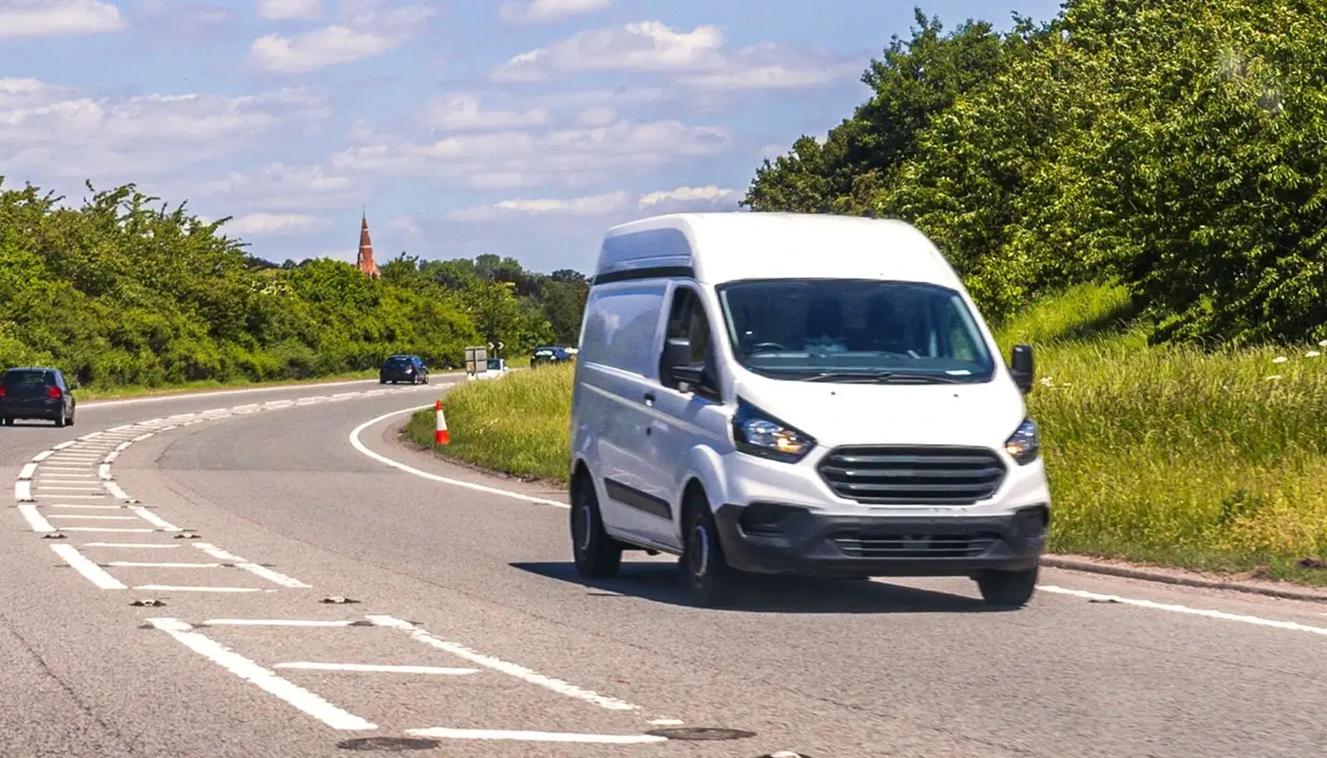 White van travelling on the road