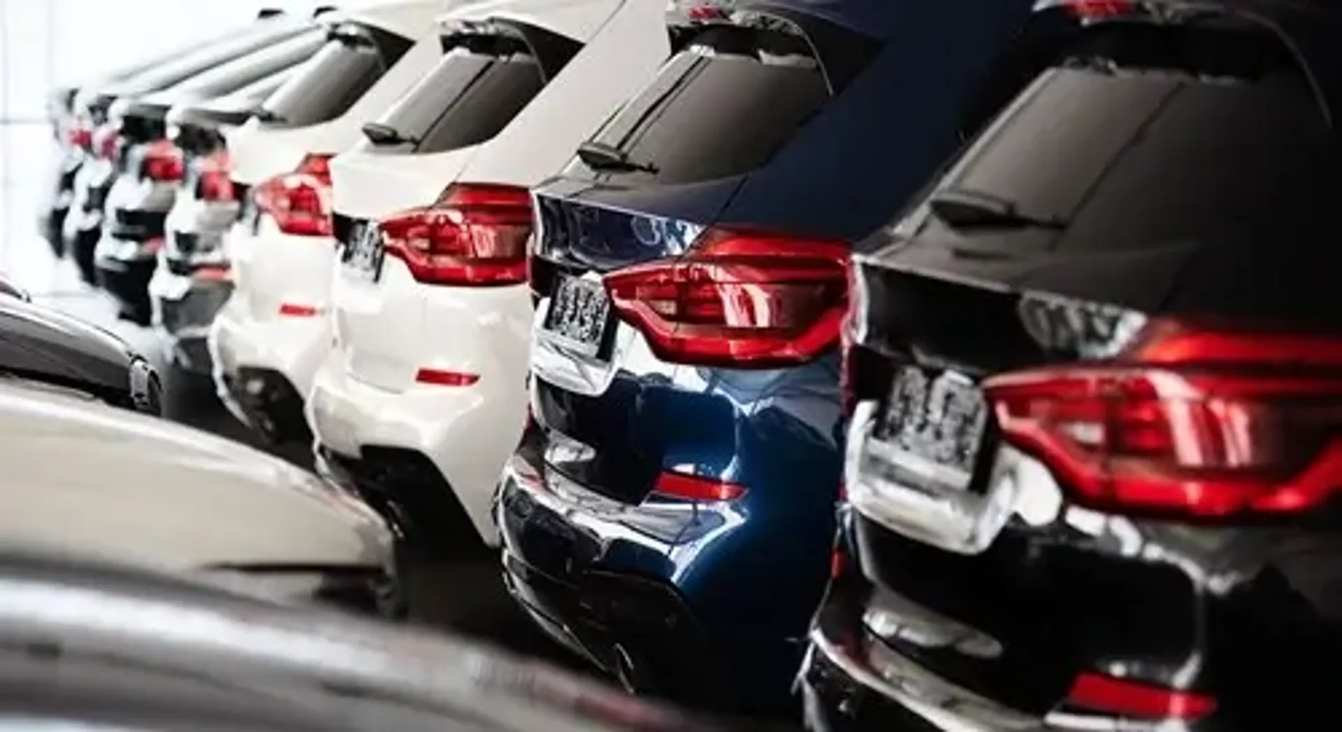 A lineup of cars on display in a showroom.