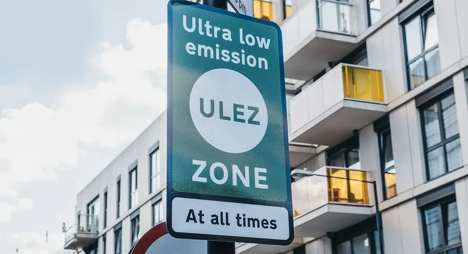 A sign displaying "Ultra Low Emission Zone at all times" indicating a restricted area for vehicles with minimal emissions.
