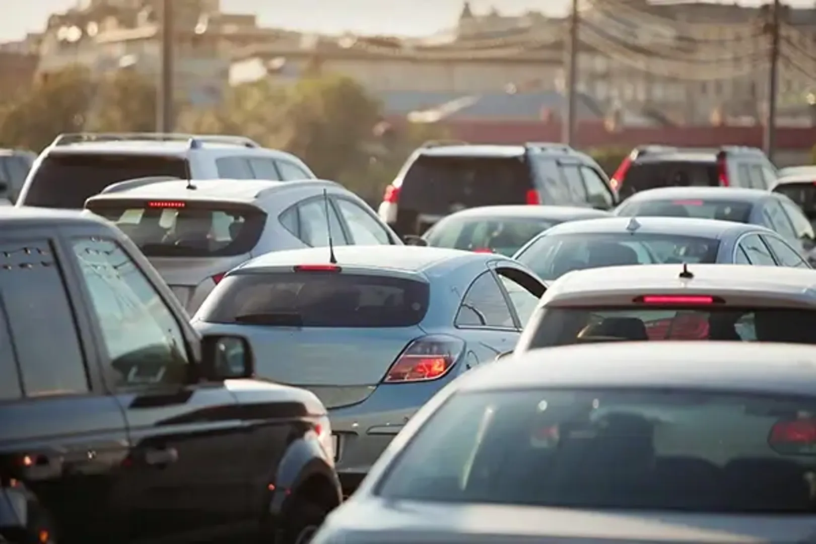 A congested traffic scene with numerous cars stuck in a jam, causing a significant delay in movement.